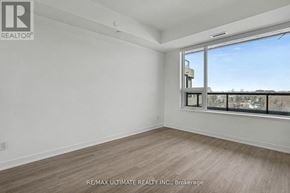 Vaughan (Uplands) condo for rent - A room with a large window and a view of buildings outside.