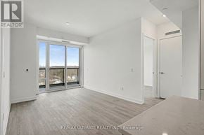 Vaughan (Uplands) condo for rent - A spacious room with a large window and sliding glass doors.