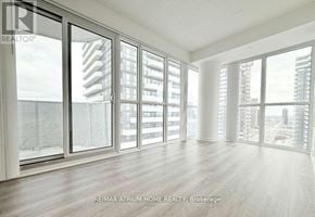 Vaughan (Vaughan Corporate Centre) condo for rent - A spacious room with large windows and wooden flooring.