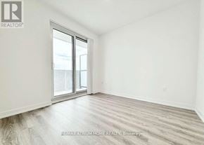 Vaughan (Vaughan Corporate Centre) condo for rent - A spacious room with a large window and wooden flooring.