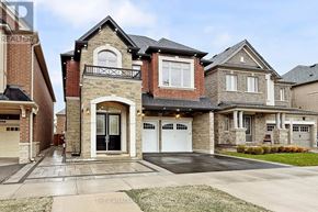 Oakville (Go Glenorchy) apartment for rent - A large, two-story house with a stone facade and a balcony on the second floor.