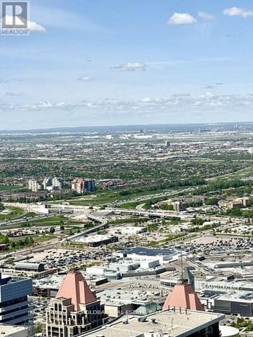 Mississauga (City Centre) condo for rent - A cityscape with a clear sky and a building with a sign that reads "GLOBAL".