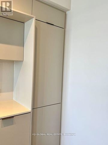 Mississauga (City Centre) condo for rent - A white kitchen cabinet with a glass door and a white shelf.