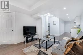 Mississauga (East Credit) apartment for rent - A modern living room with a glass coffee table and a flat screen TV.