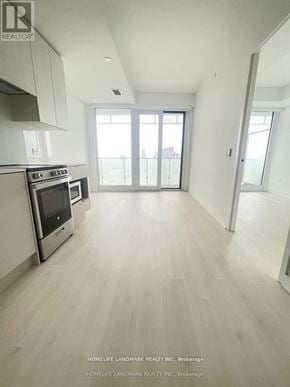Mississauga (City Centre) condo for rent - A spacious kitchen with white cabinets and a stainless steel oven.