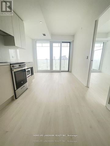 Mississauga (City Centre) condo for rent - A spacious kitchen with white cabinets and a stainless steel oven.