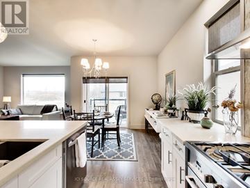 Port Colborne (Sugarloaf) apartment for rent - A well-lit kitchen with a dining table and chairs.