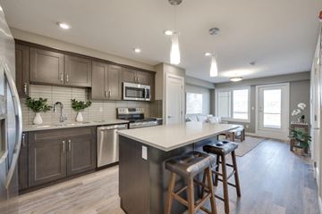 Edmonton apartment for rent - A modern kitchen with a large island and stainless steel appliances.