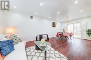 Toronto (Clairlea-Birchmount) apartment for rent - A living room with a white couch and a glass coffee table.
