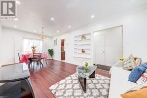 Toronto (Clairlea-Birchmount) apartment for rent - A living room with a glass coffee table and a dining table with chairs.