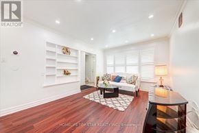 Toronto (Clairlea-Birchmount) apartment for rent - A well-lit, spacious living room with a dark wood floor and white walls.
