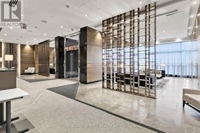 Toronto (Willowdale East) condo for rent - A modern office lobby with a glass partition and a reception desk.