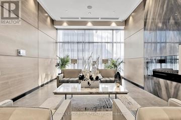 Toronto (Willowdale East) condo for rent - A modern living room with a glass table and chairs.