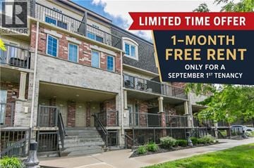 Kitchener townhouse for rent - A building with a sign offering a 1-month free rent for a September 1st tenancy.