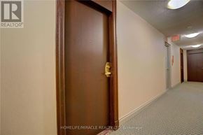 Toronto (Waterfront Communities) condo for rent - A hallway with a brown door and a white wall.