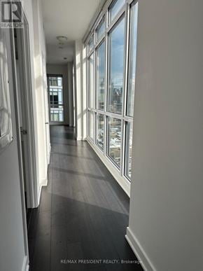 Toronto (Kensington-Chinatown) condo for rent - A long hallway with windows on the side.