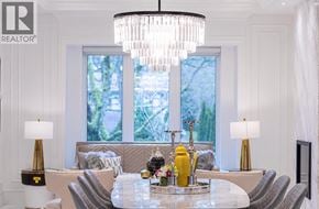 Vancouver apartment for rent - A well-lit dining room with a chandelier and a table set for a meal.