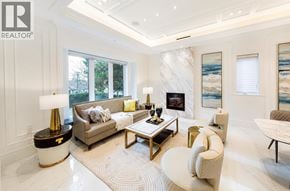 Vancouver apartment for rent - A well-lit, modern living room with a grey sofa, a coffee table, and a large window.