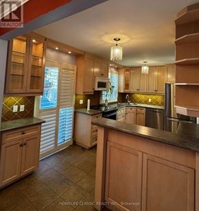Richmond Hill (Mill Pond) apartment for rent - A kitchen with wooden cabinets and a stainless steel refrigerator.