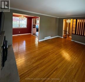 Richmond Hill (Mill Pond) apartment for rent - A room with wooden floors and a chandelier.