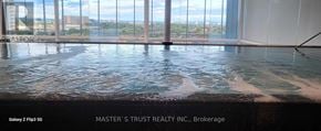 Mississauga (City Centre) condo for rent - A pool with a view of the city through the windows.