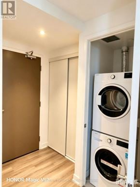 Mississauga (City Centre) condo for rent - A washing machine is installed in a wall-mounted cabinet.
