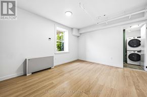 Hamilton (Corktown) multi-family for rent - A room with a window and a washing machine in it.