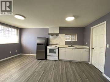 Burnaby apartment for rent - A kitchen with a refrigerator, oven, and sink.
