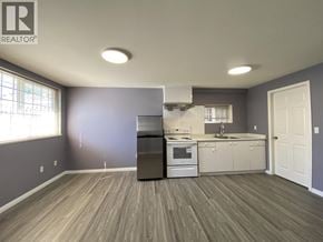 Burnaby apartment for rent - A kitchen with a stove, oven, and cabinets.