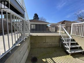 Burnaby apartment for rent - A concrete pool area with a metal railing and steps.