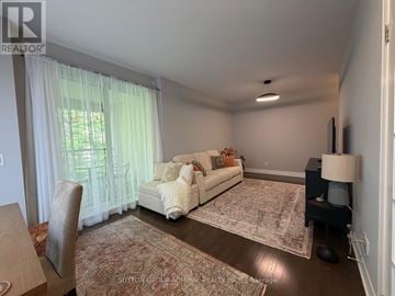 Toronto (Bayview Village) condo for rent - A living room with a white couch and a rug.
