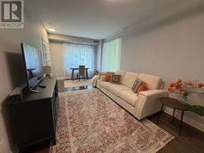 Toronto (Bayview Village) condo for rent - A living room with a white couch and a rug.