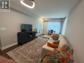Toronto (Bayview Village) condo for rent - A living room with a couch, a television, and a rug.