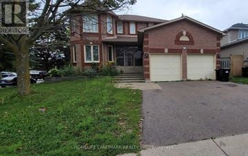 Barrie (Ardagh) apartment for rent - A red brick house with a white garage door is for sale.