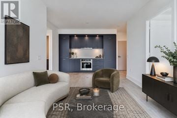 Toronto (Dovercourt-Wallace Emerson-Junction) condo for rent - A modern living room with a sofa, armchair, and a coffee table.