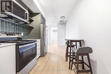 Hamilton (Corktown) multi-family for rent - A kitchen with a white oven and a white wall.