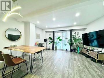 Mississauga (Mississauga Valleys) townhouse for rent - A modern living room with a wooden table and chairs.