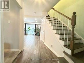 Mississauga (Mississauga Valleys) townhouse for rent - A hallway with a staircase and a door leading to a balcony.