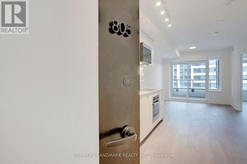 Markham (Unionville) condo for rent - A modern kitchen with a stainless steel refrigerator and wooden flooring.