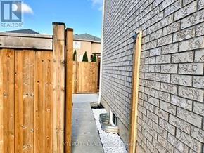 Bradford West Gwillimbury (Bradford) apartment for rent - A wooden fence and a brick wall are visible in the image.