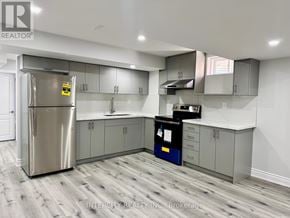Bradford West Gwillimbury (Bradford) apartment for rent - A kitchen with a stainless steel refrigerator and wooden flooring.