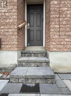 Vaughan (Maple) apartment for rent - A black door with a brass handle is on a brick wall.