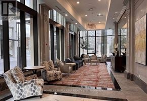 Mississauga (Fairview) condo for rent - A large, well-lit lobby with a red carpet and comfortable seating.