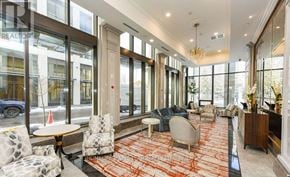 Mississauga (Fairview) condo for rent - A large, well-lit room with a variety of seating options and a chandelier.