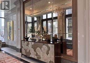 Mississauga (Fairview) condo for rent - A reception area with a large mirror and a decorative console.