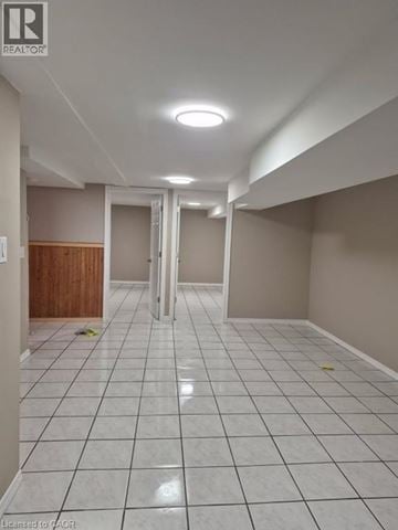 Hamilton apartment for rent - A kitchen with white cabinets and a stainless steel refrigerator.