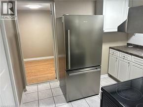 Hamilton apartment for rent - A kitchen with a refrigerator and a stove top oven.