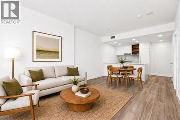 Burnaby apartment for rent - A living room with a white couch, a coffee table, and a painting on the wall.