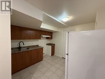 Brampton (Northwest Brampton) apartment for rent - A kitchen with brown cabinets and a white refrigerator.