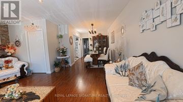 Mississauga (Erindale) apartment for rent - A well-lit living room with a wooden table and a sofa.